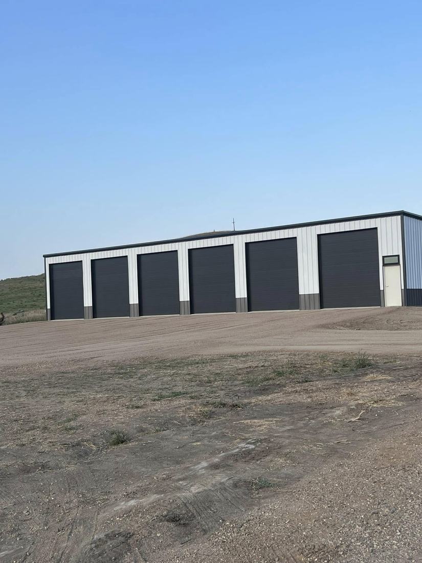 The six-unit storage building with large overhead doors